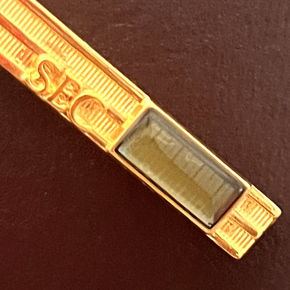 Close-up of the silicon chip under its clear window, beside the raised letters SEC